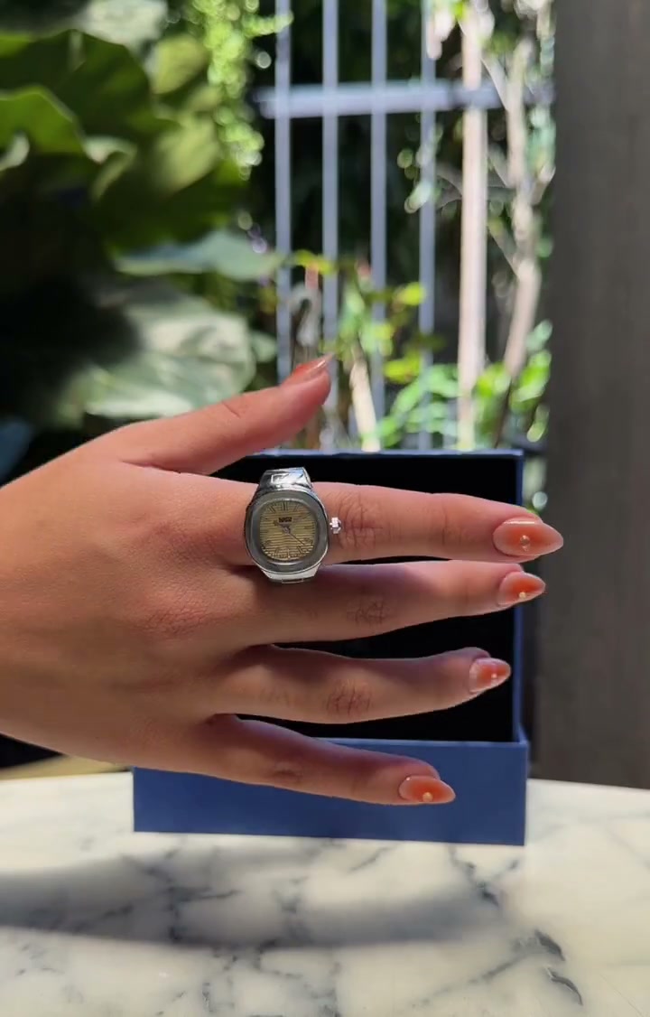 Client wearing a silver EARTH PLUS FIRE Aura Watch Ring