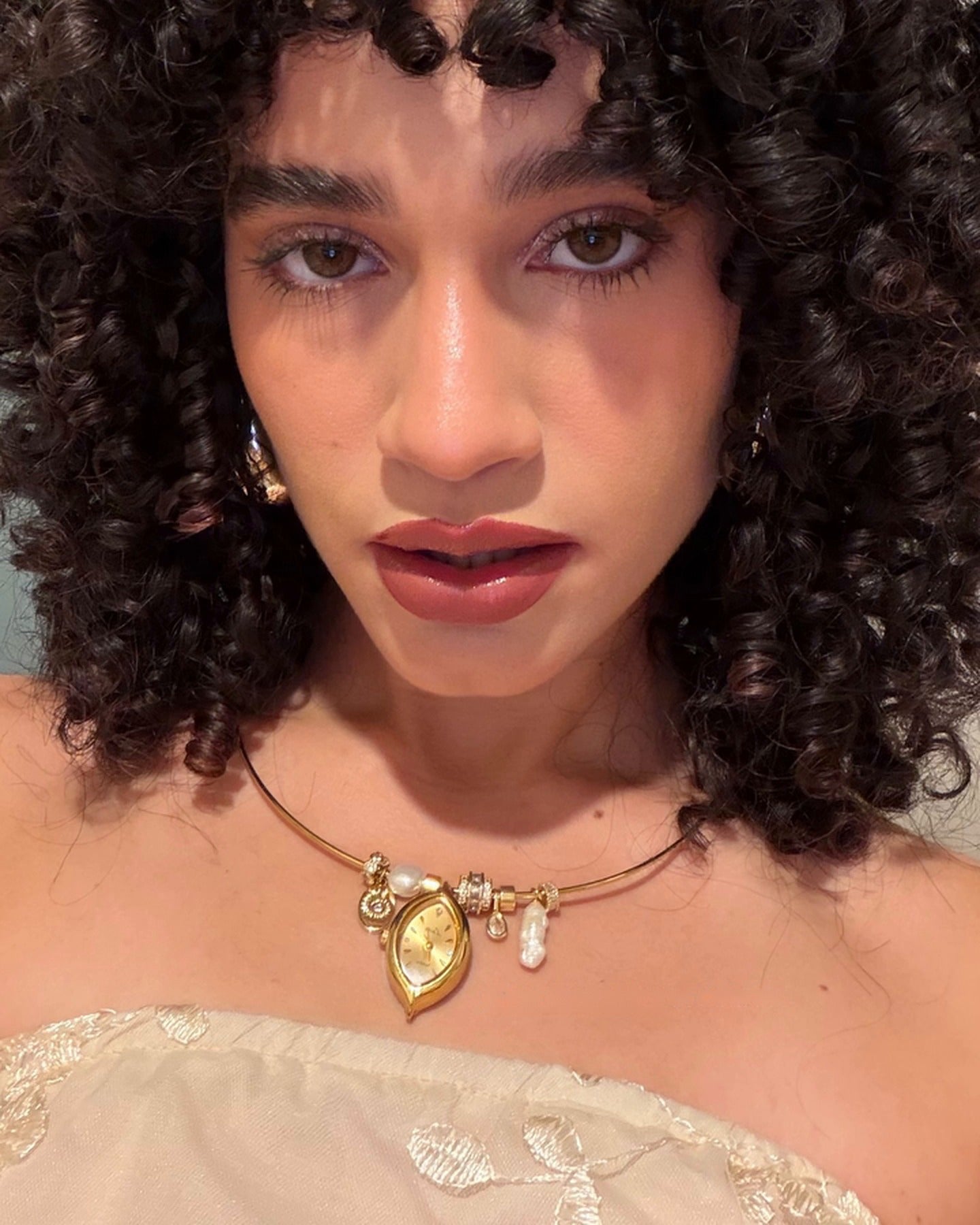 Client wearing the EARTH PLUS FIRE Soleil Watch Necklace in gold