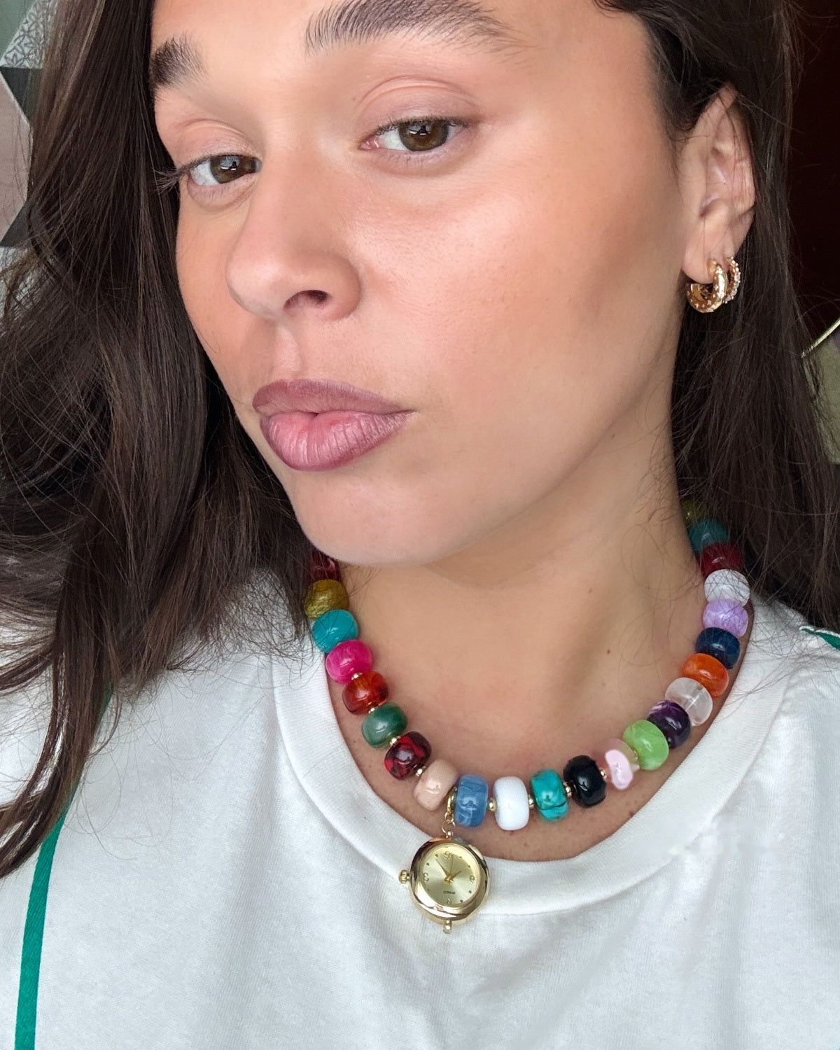 Client wearing the EARTH PLUS FIRE Calipso Watch Necklace