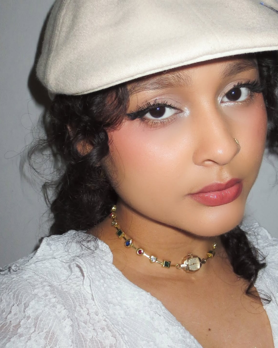 Portrait of a client wearing the EARTH PLUS FIRE Latido Watch Choker in gold